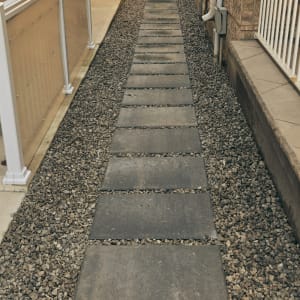 The side area of this property lacked both function and visual appeal, so the goal was to create a practical and tidy solution. Pre-cast concrete patio stones were installed to form a clean walkway, while the backyard lawn was refreshed with new sod. The result is a neat and welcoming space that complements the rest of the property. Project 13 Side Yard Transformation